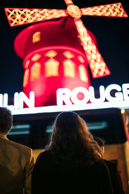 people are watching a giant lit up building