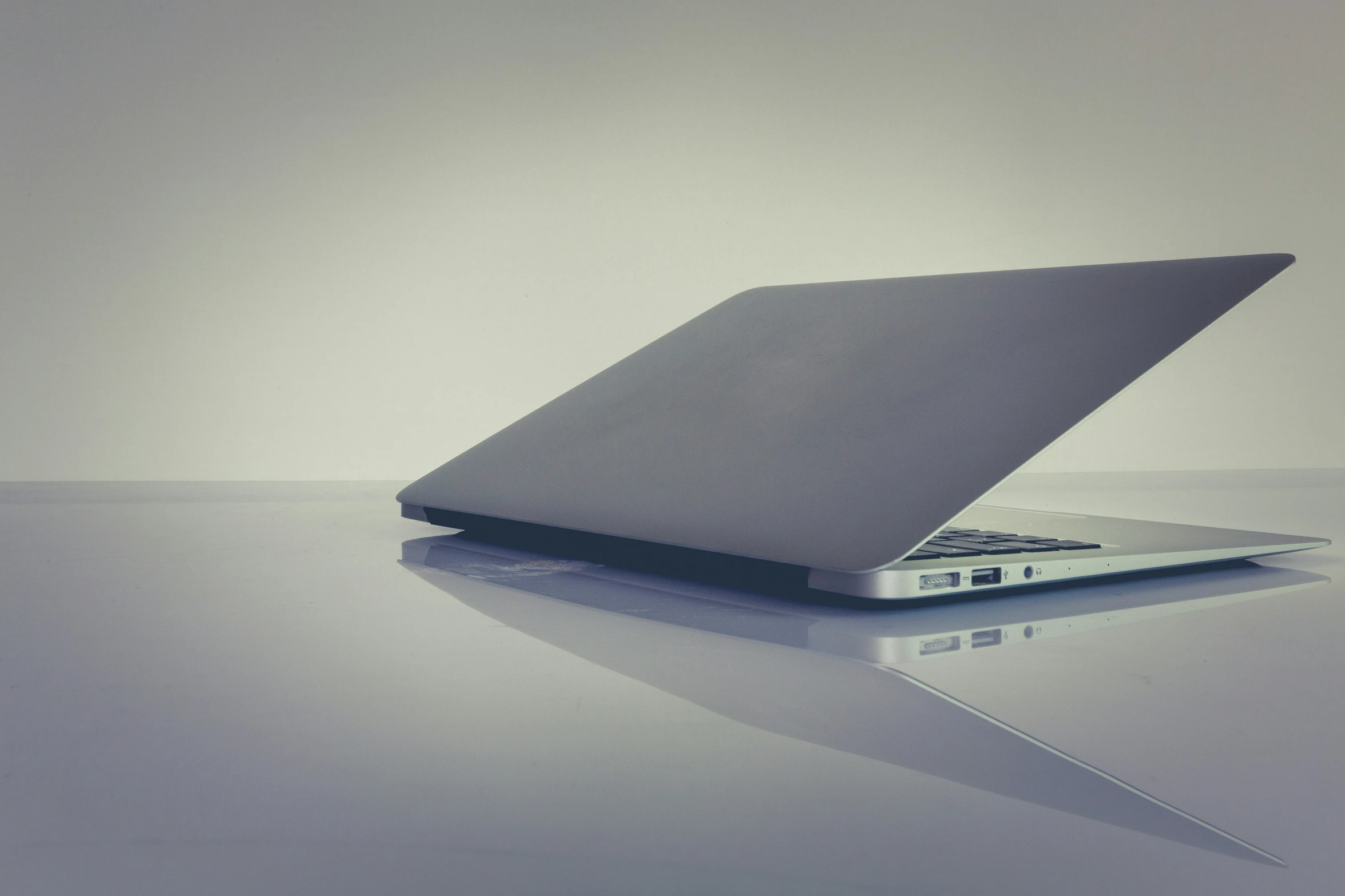 an empty laptop computer sitting on a table