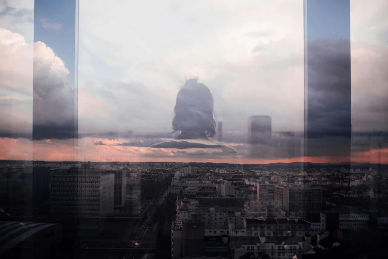 a large picture taken out a skyscr with a person looking out