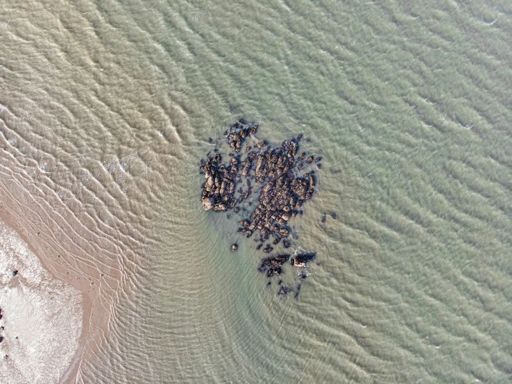 a bunch of sand sitting in the middle of the ocean