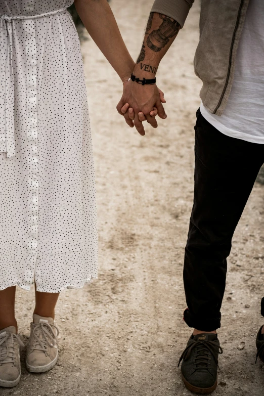 a man and woman holding hands with an old fashion outfit