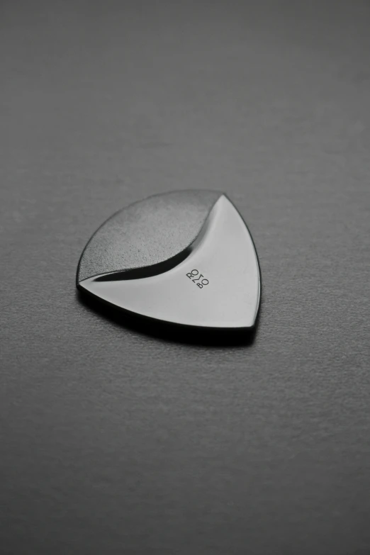 a guitar pick with a black and white background