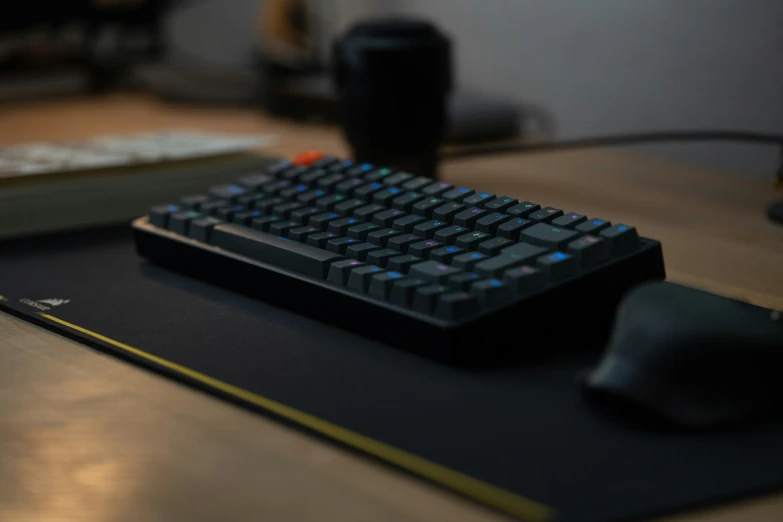 a computer mouse sits on a black computer keyboard