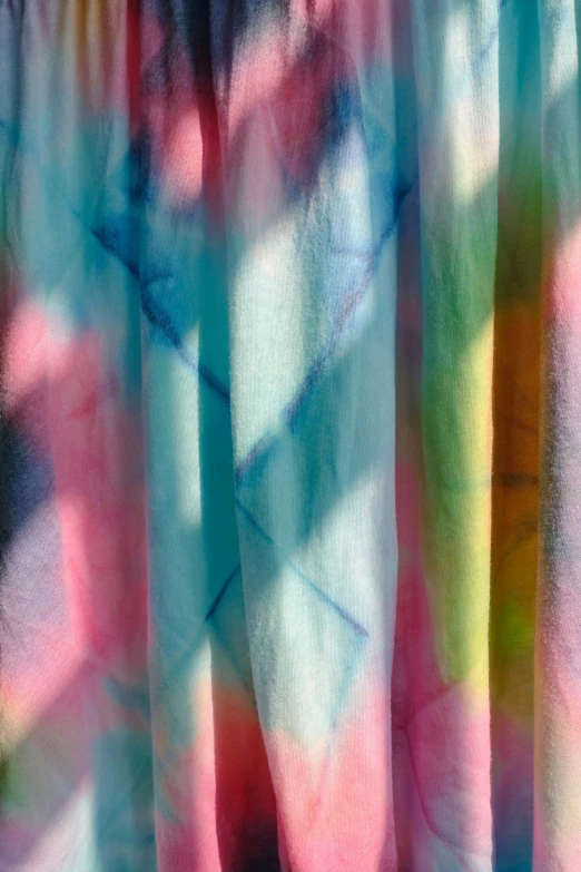 a sheered fabric with colored clouds and a tie dye design