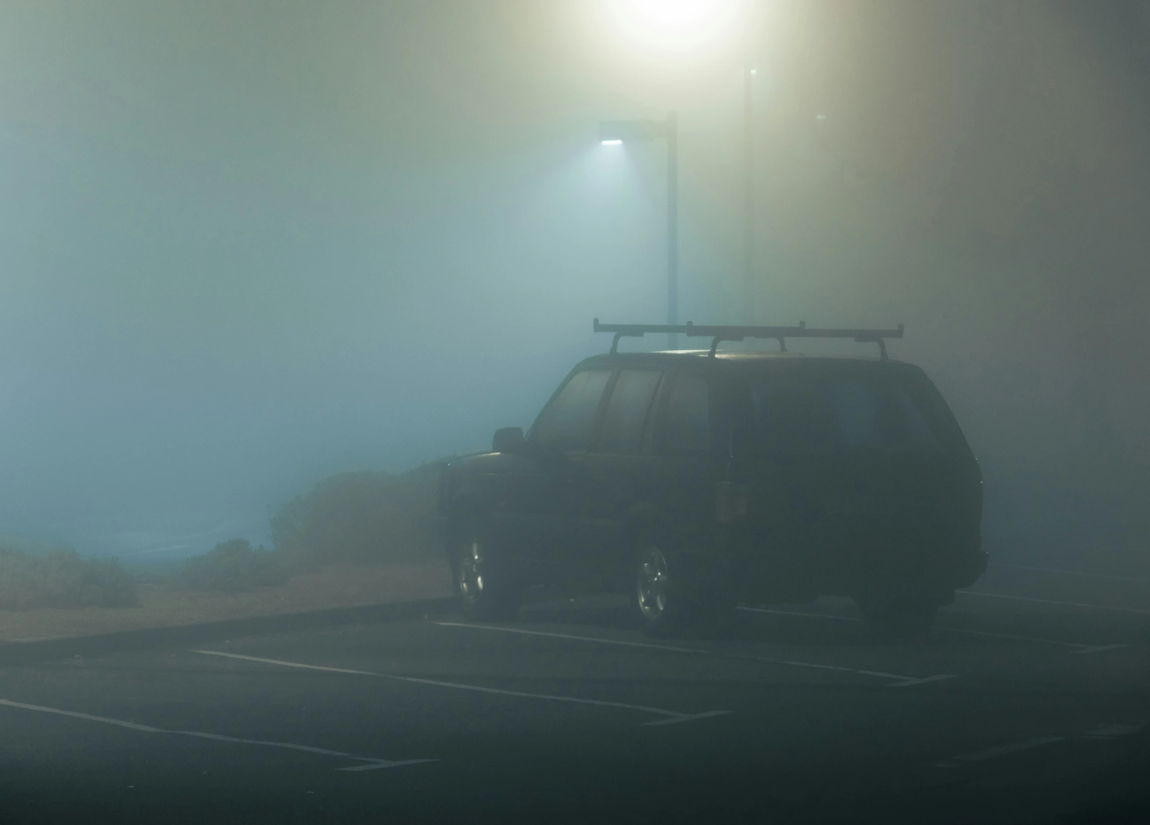 a small car driving on a street at night