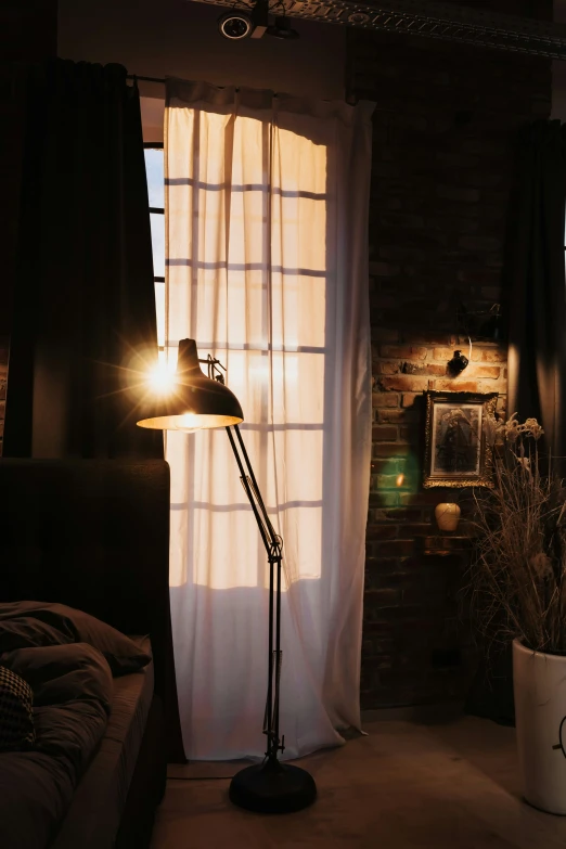 a floor lamp sitting in front of a window