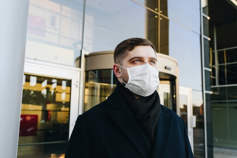 a man is outside wearing a face mask