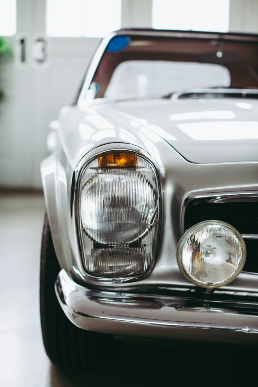 the front view of a modern classic car, showing its lights