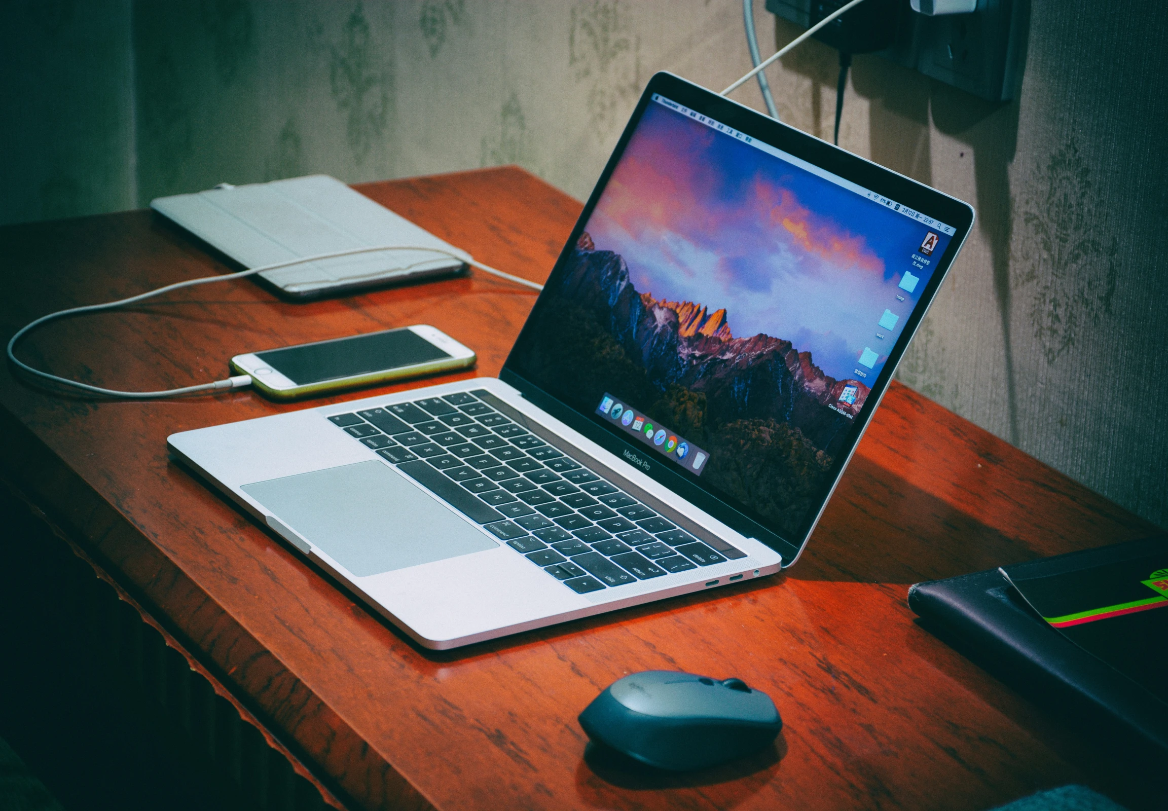 laptop computer and mouse on desk with wood table