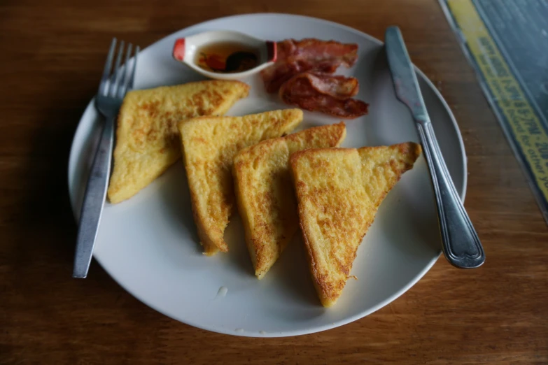 a plate of food that includes fried cheese and eggs