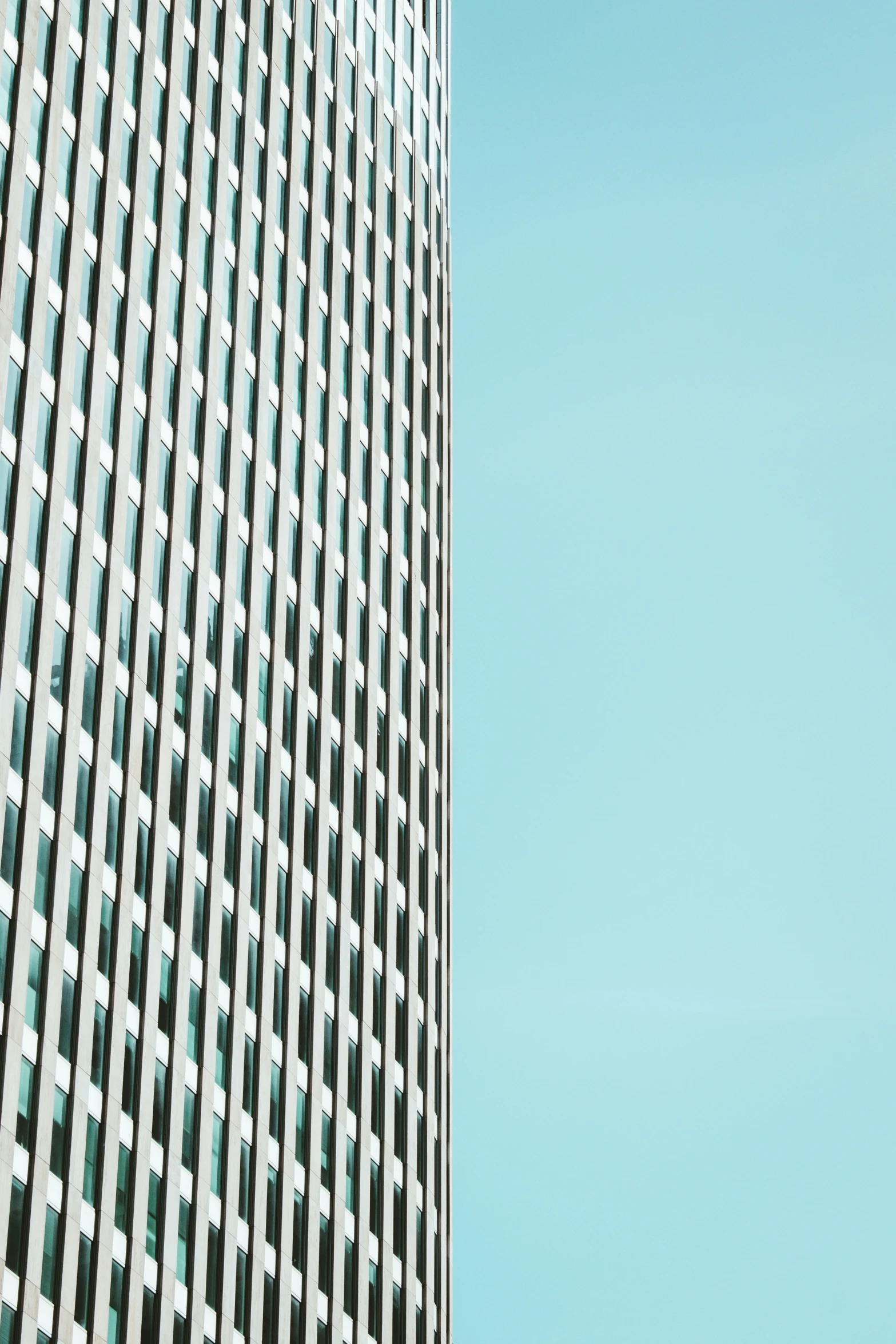 an airplane flying low over the top of a tall building