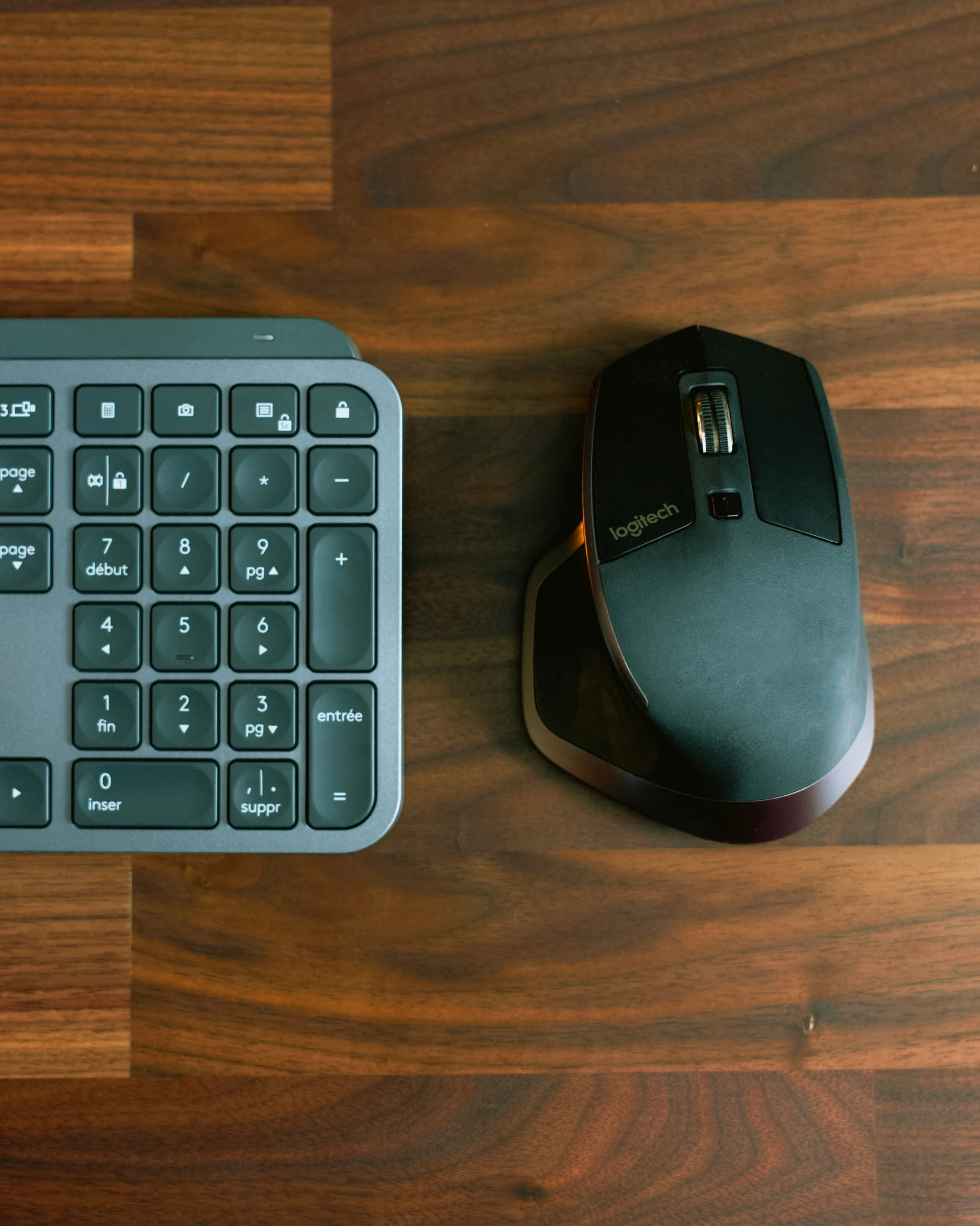 a black computer mouse with an orange and white keyboard