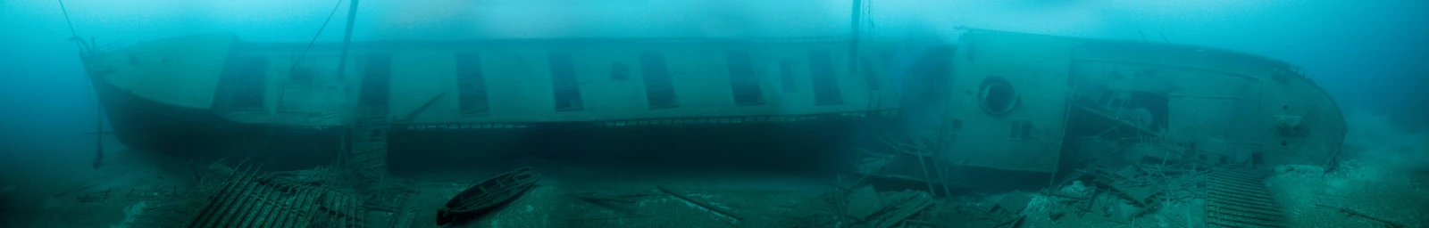 a boat is covered in debris by the ocean