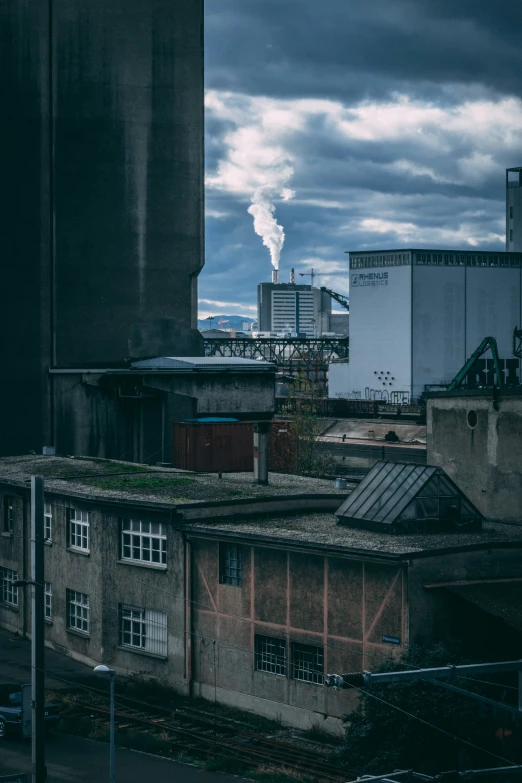 view from across the train track of some buildings and factories