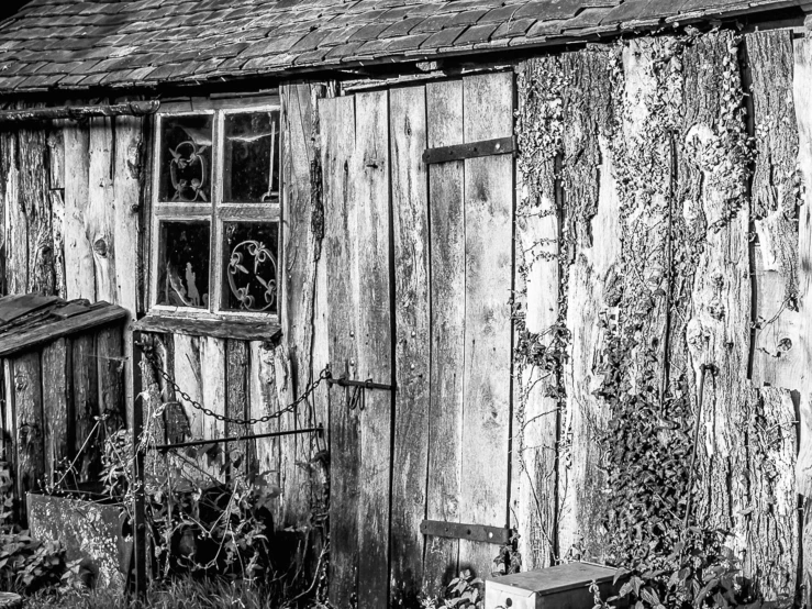 a black and white pograph of an old run down building