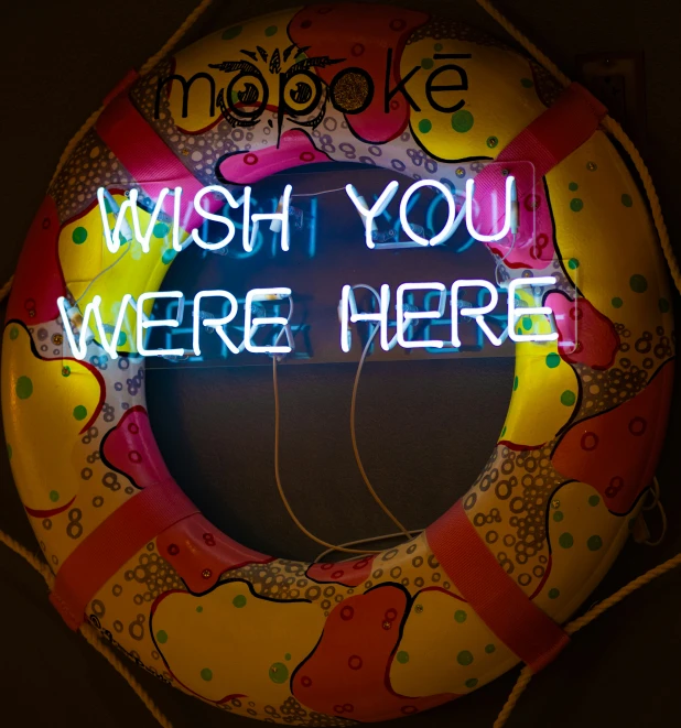 a life preserver with a neon sign saying'wish you were here '
