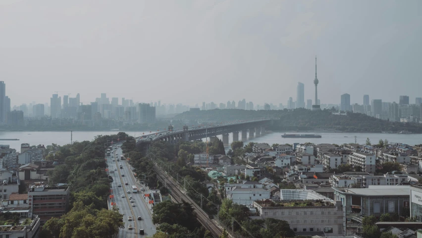 an aerial view of a city with a river and a bridge