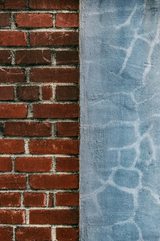 a red brick wall with some blue bricks