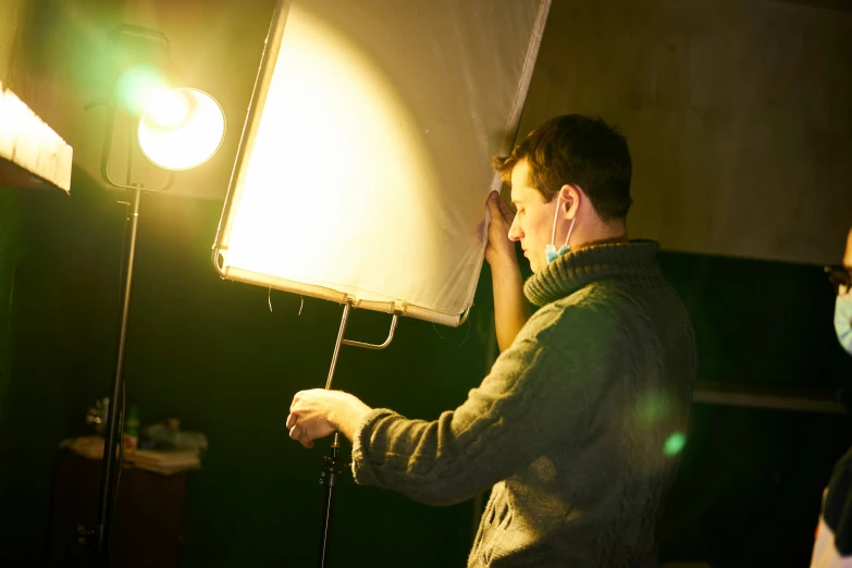 a person holds the arm of a light bulb