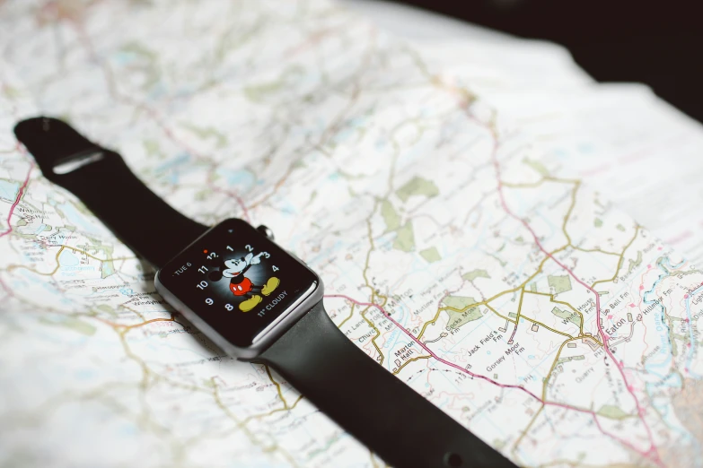 an apple watch laying on top of a map