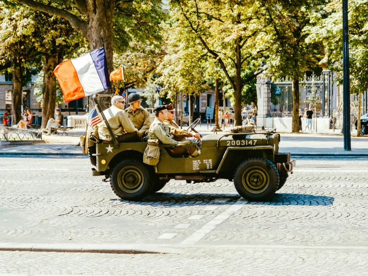 three soldiers are riding in the back of a military truck