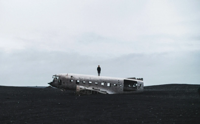 a person standing on top of a large plane