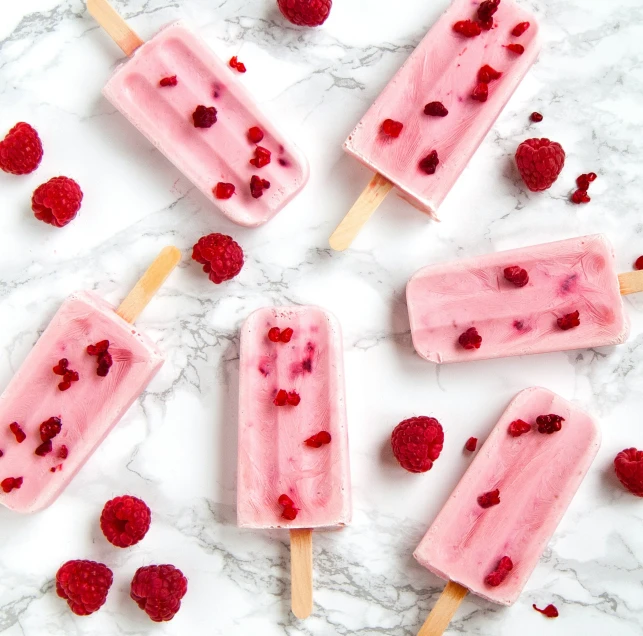 raspberry popsicles with the text, strawberry yogurt popsicles recipe