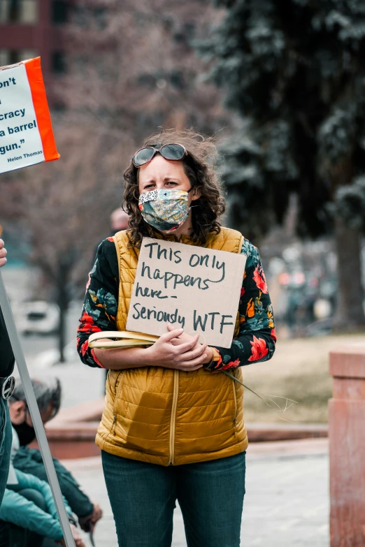 a woman holding a sign and a microphone