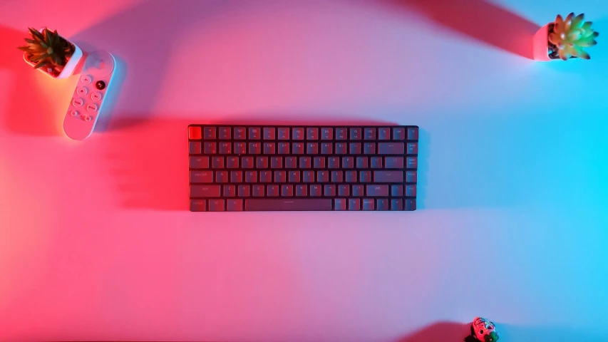 two remote controls and an electronic keyboard with red and blue lights in the background