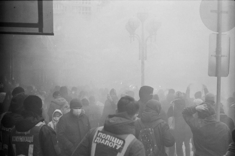 a group of people standing around and walking in the fog