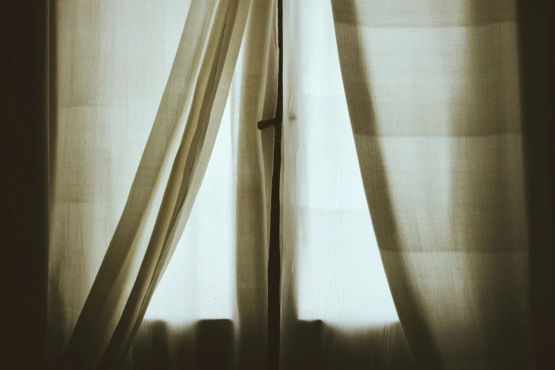 an open curtains with a long light curtain hanging over it