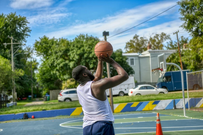 the young man is shooting the basketball to the basket