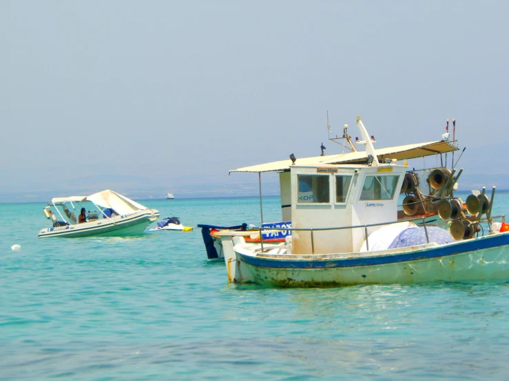 three boats in the middle of the water