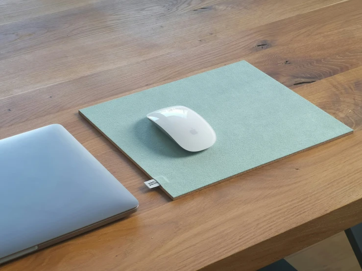 a wooden table with a laptop and mouse pad