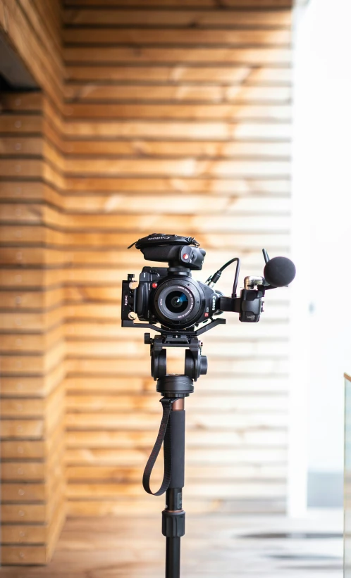 the camera is set up in a room with a wood background