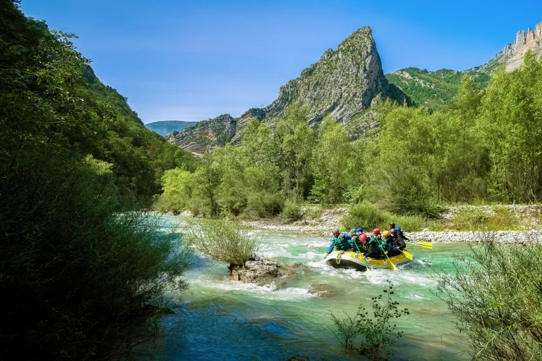 two people on the river with a raft on the ground