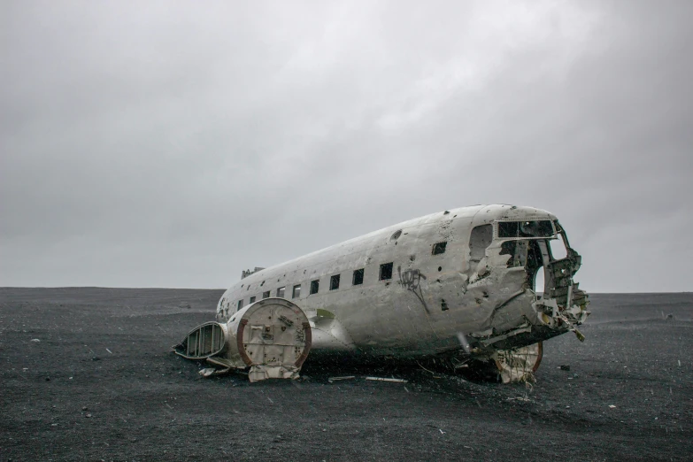 an old plane that is on some dirt