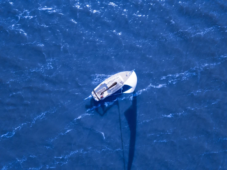 a small boat floating on the water at an angle