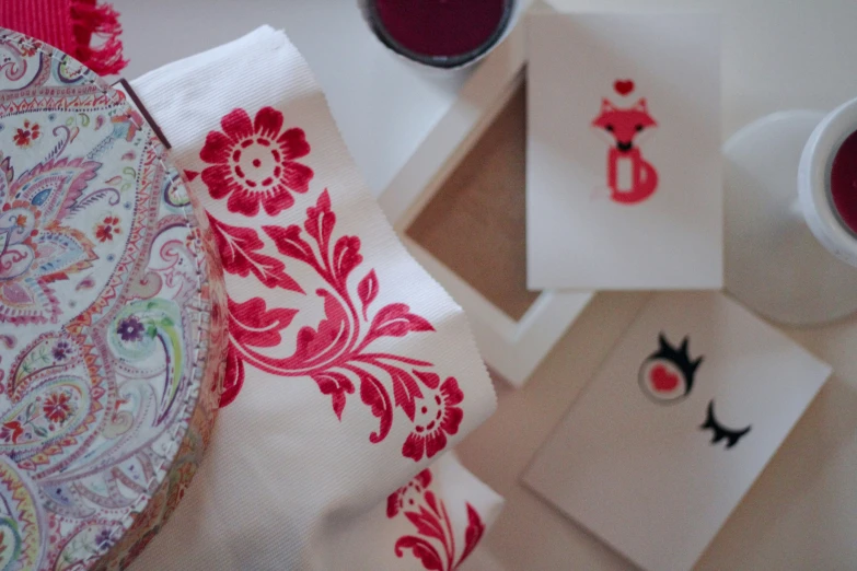 a table topped with napkins and some paintings