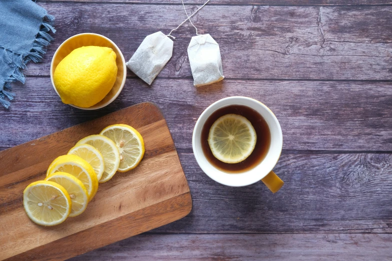 a cup of tea with lemons and sugar cubes