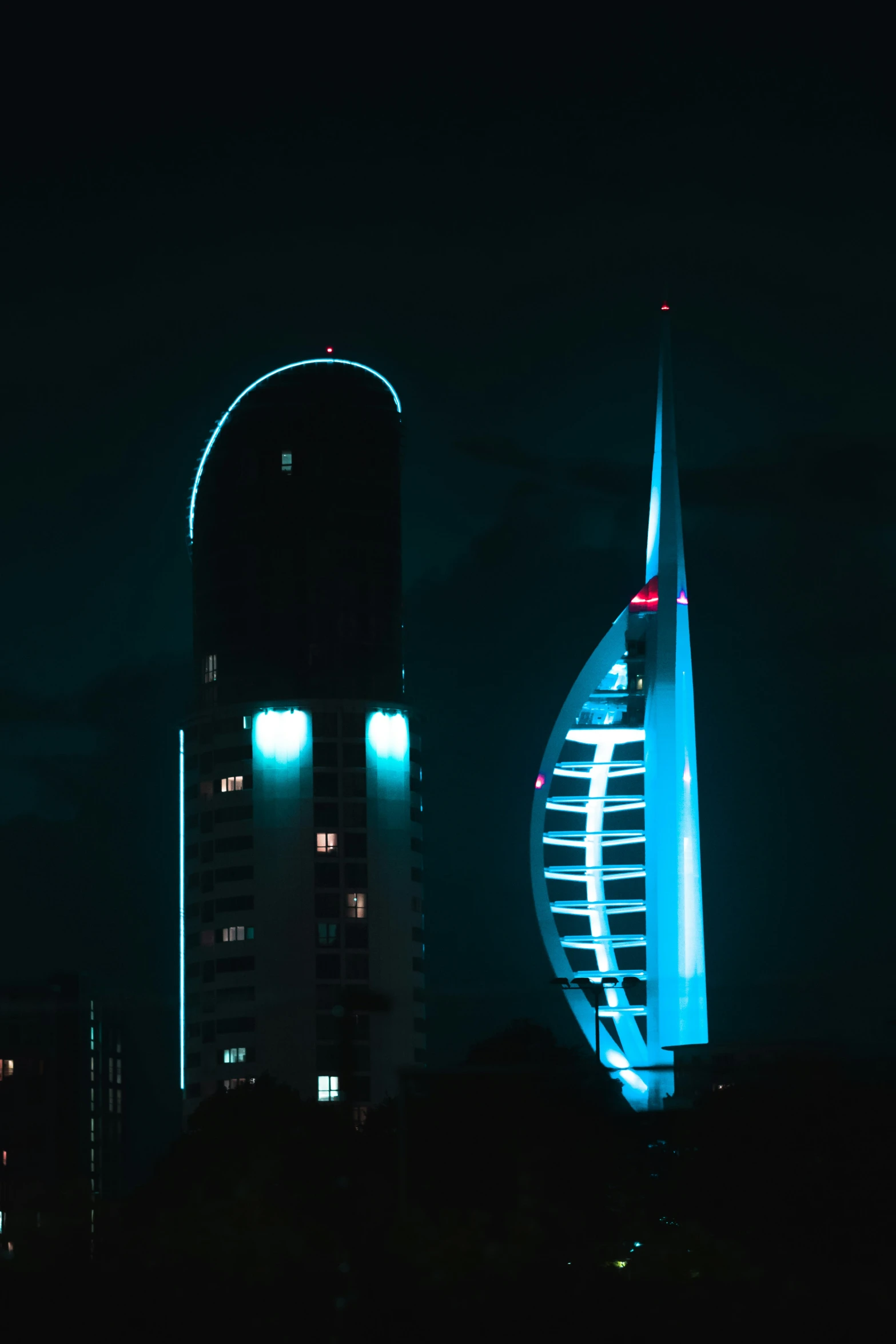 city skylines lit up at night at the base of skyscrs