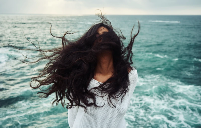 a girl with hair flowing out from her back