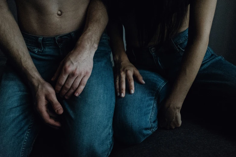 two young women sitting next to each other with their arms wrapped around each other