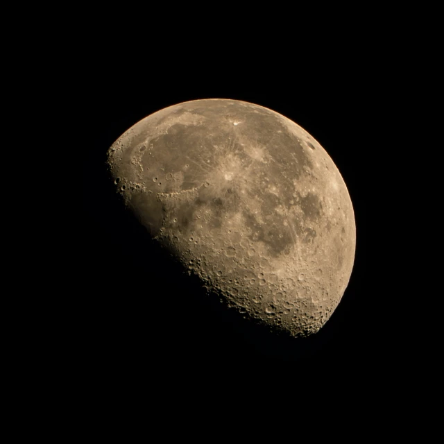 a large, round object with a small amount of moon visible over it