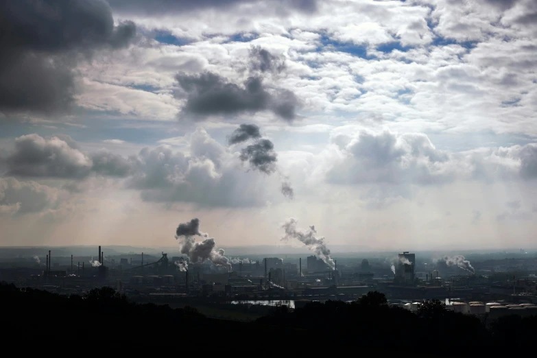 smokestacks rise into the distance over the city