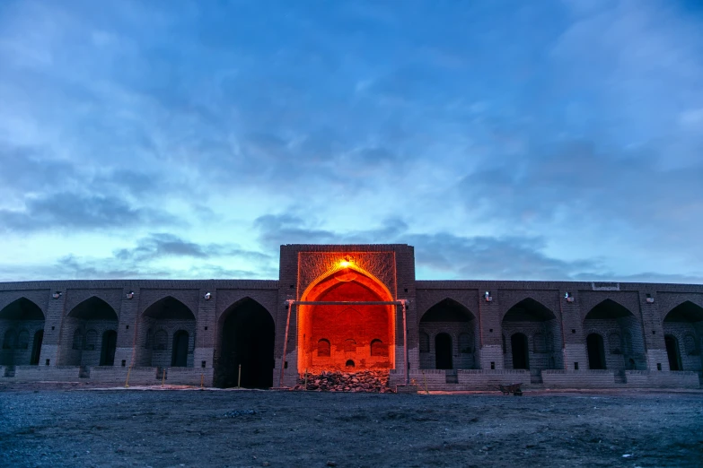 a view of an old castle with a lit entrance