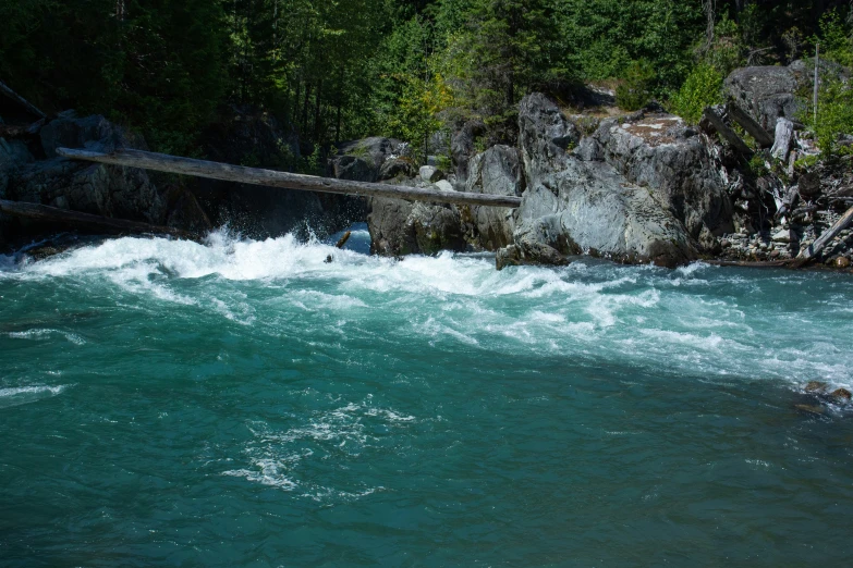 there is a man riding the waves in the river