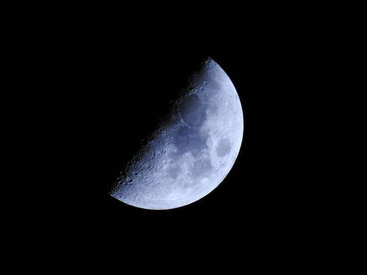 a half moon lit up in the sky