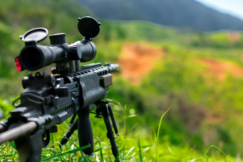 rifle scope on tripod of camera set up outside