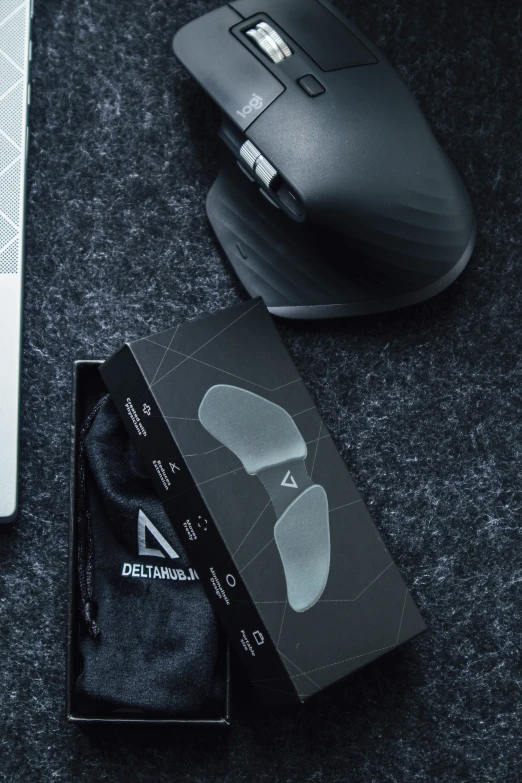 a mouse and black card on the table next to a wireless mouse